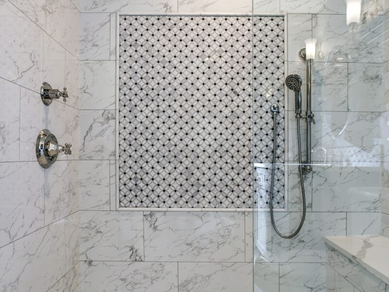 Shower Remodel Matthews, NC: Walk-in shower with Carrera marble surround and mosaic accent tiles for an elegant touch.