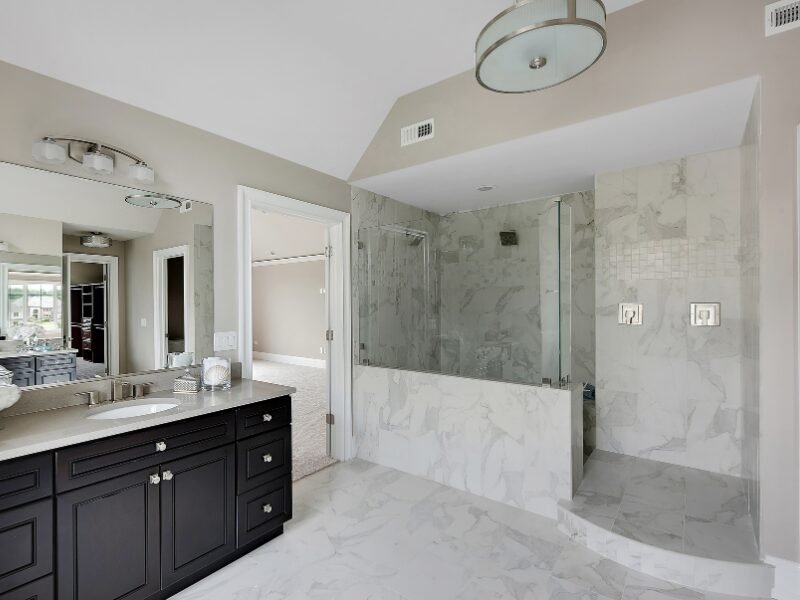 Shower Remodel Matthews, NC: Walk-in shower showcasing exquisite marble detailing for a refined and elegant look.